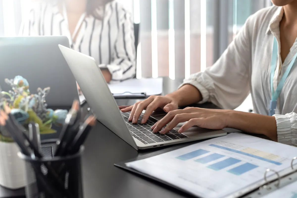 Businesswoman-sitting-using-laptop-computer-on-des-2025-03-08-00-06-52-utc
