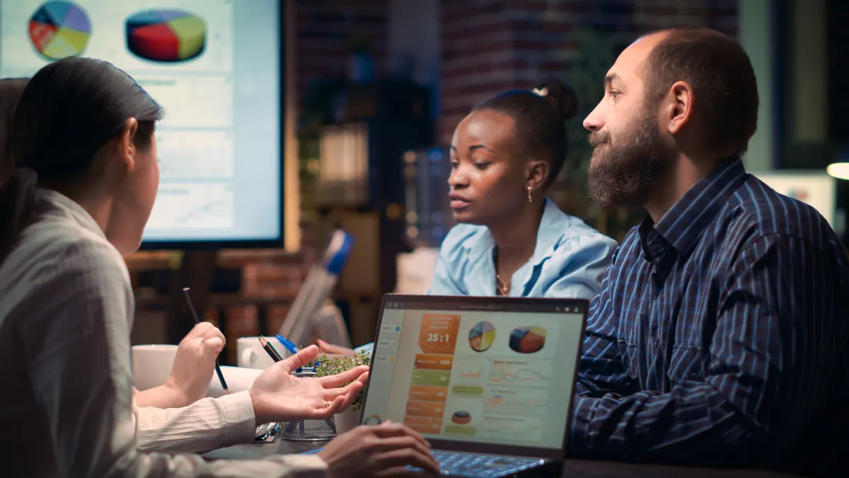 Coworkers-discussing-revenue-statistics-presentati-2023-11-27-04-49-50-utc
