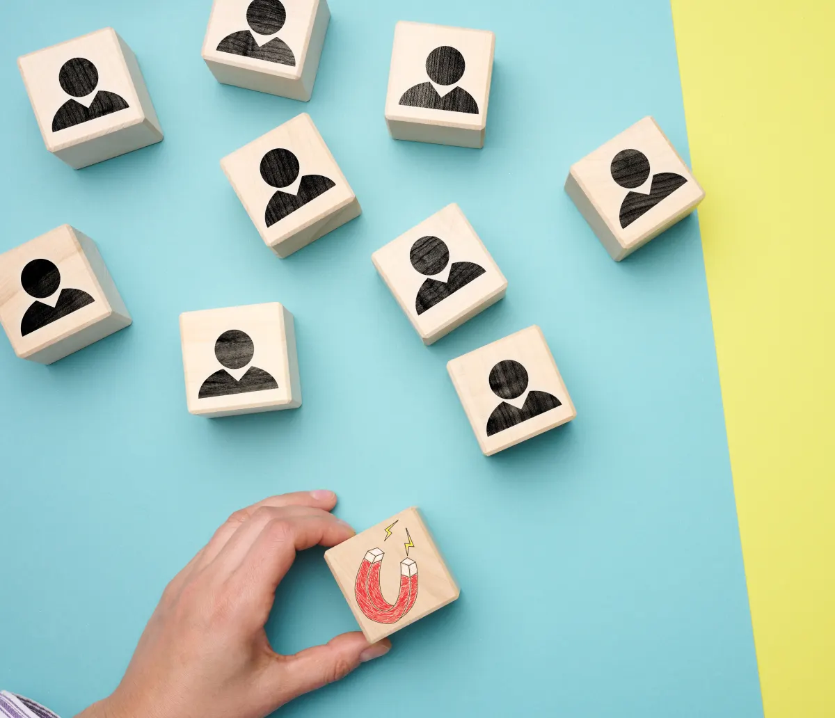 Female-hand-holds-a-wooden-cube-with-a-magnet-and-2025-03-24-05-38-11-utc