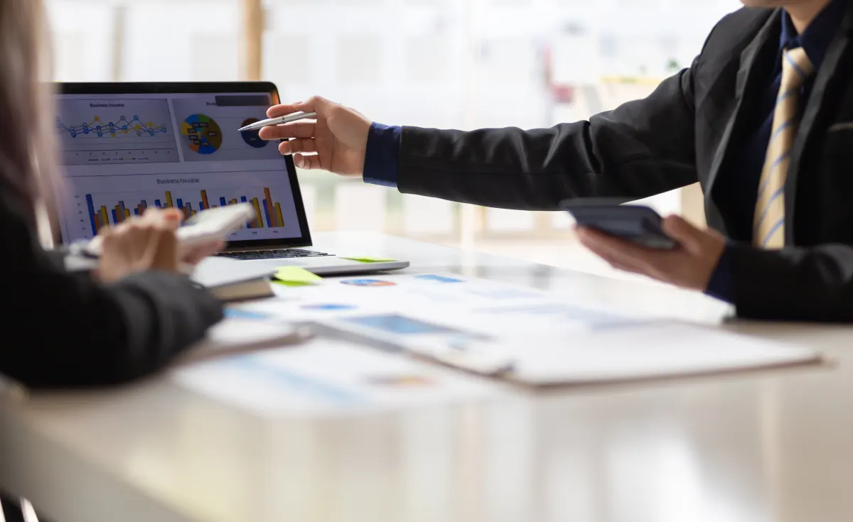 A team member pointing out the benefits of hiring a fractional CMO.