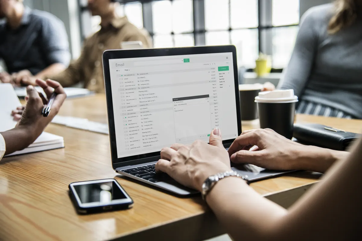 Woman-checking-her-email-in-a-meeting-2023-11-27-05-18-46-utc