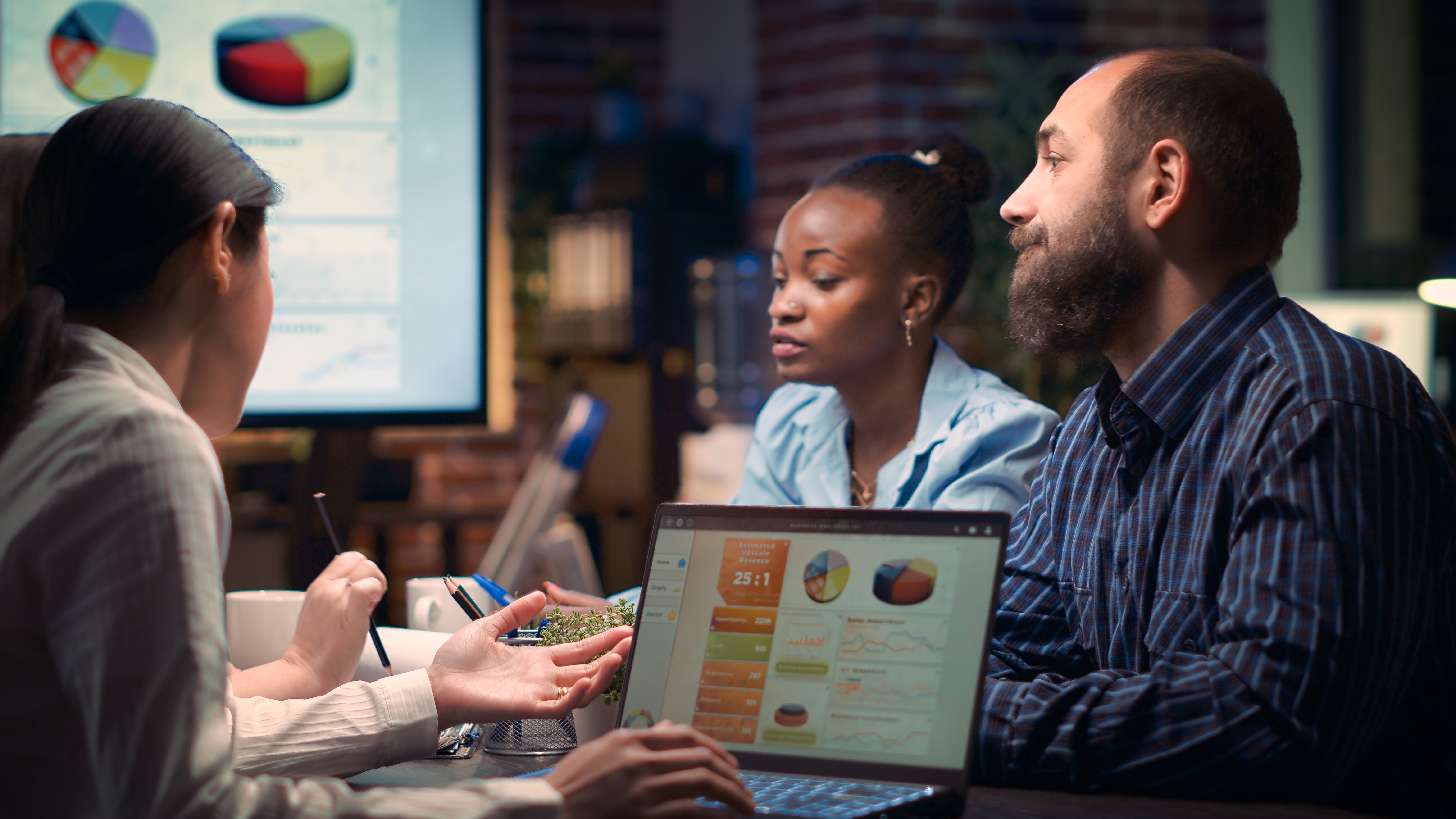 coworkers-discussing-revenue-statistics-presentati-2023-11-27-04-49-50-utc