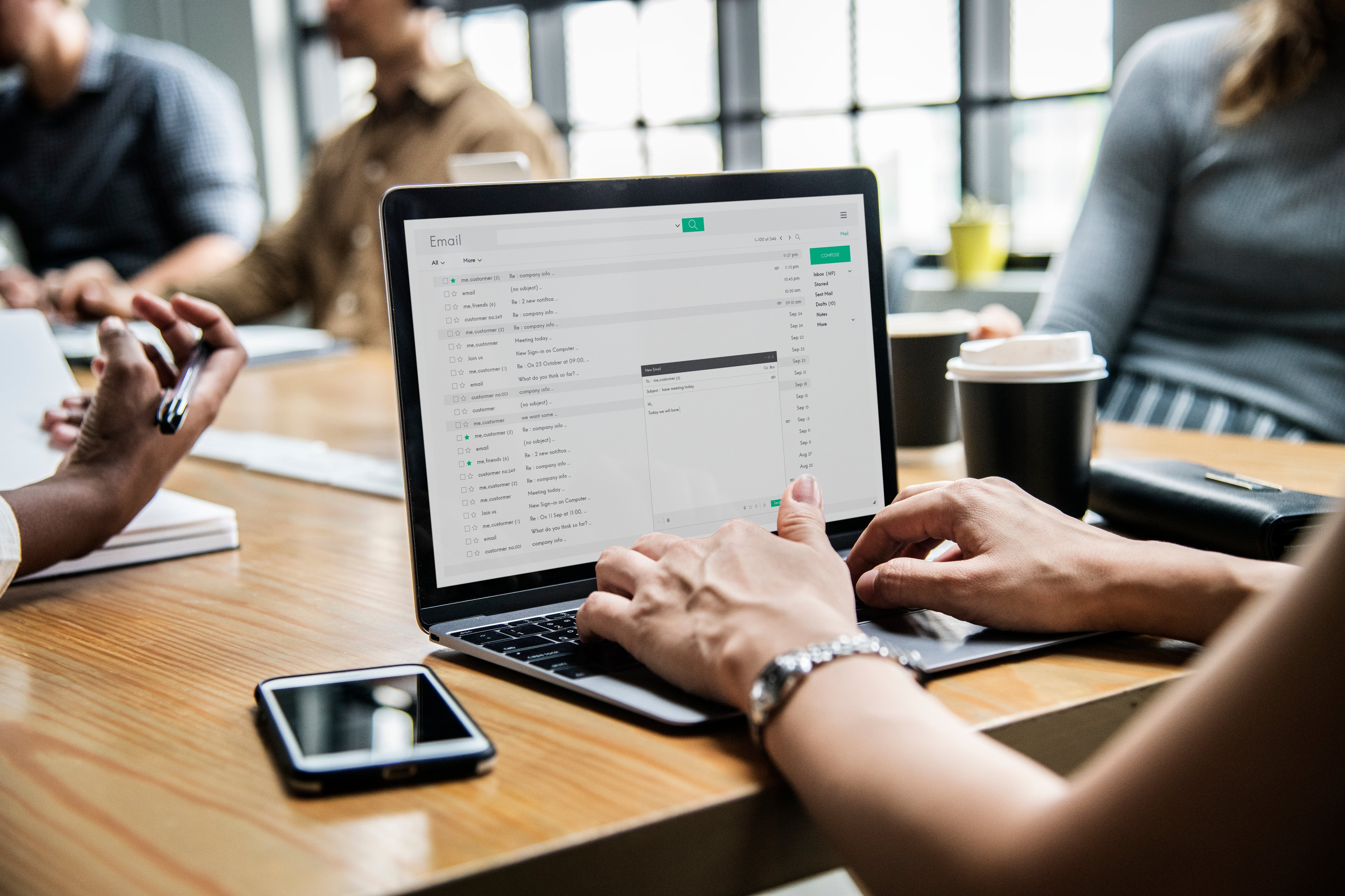 woman-checking-her-email-in-a-meeting-2023-11-27-05-18-46-utc