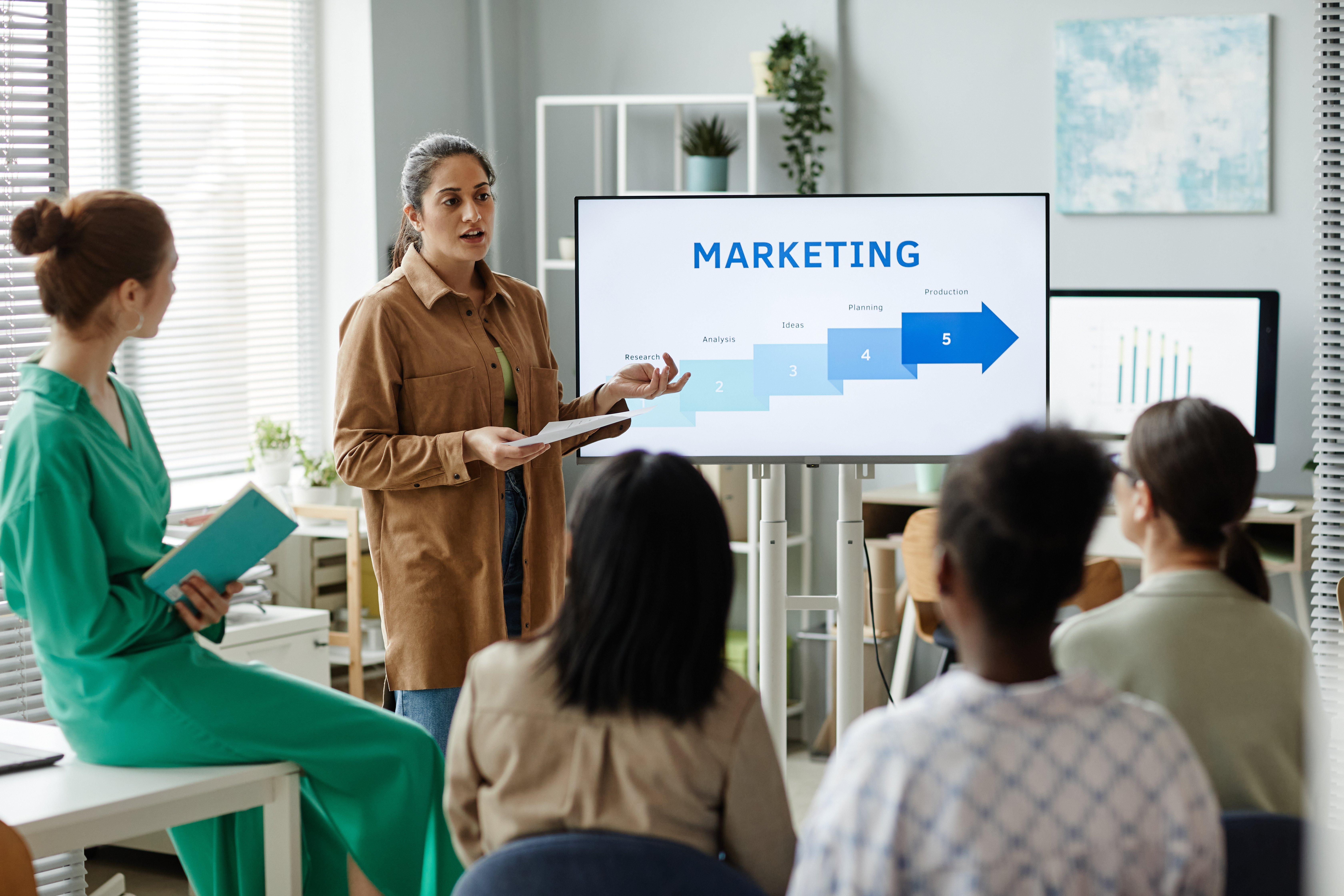 CMO presenting a marketing strategy to a team.